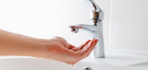 hand under faucet with low pressure water stream